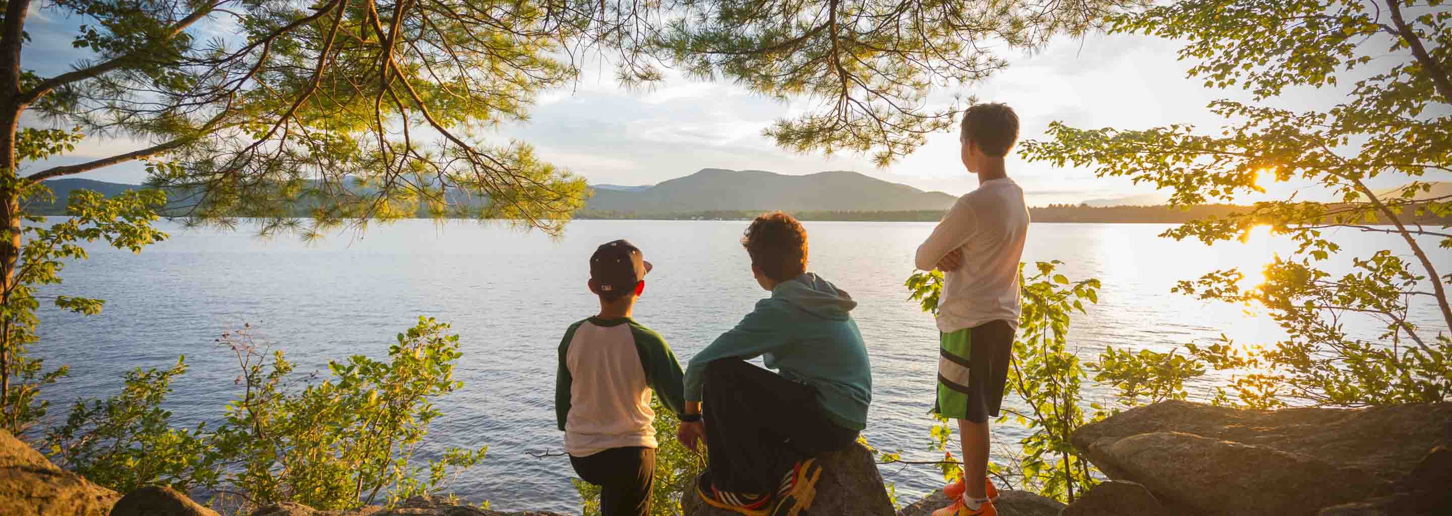 Boy campers look at the lake at summer camp