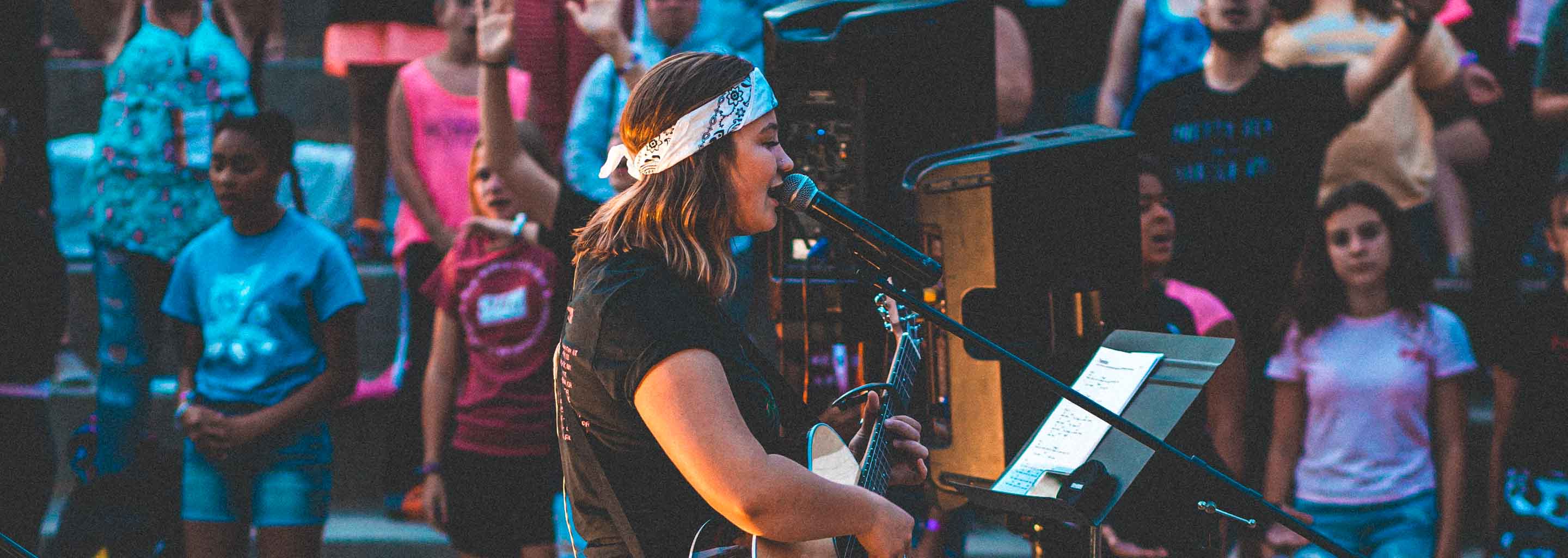 Counselor sings at Girl Scouts camp